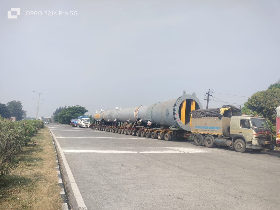 Heavy industrial equipment transported on a multi-axle trailer